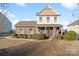 Charming two-story home featuring a brick facade, covered porch, and well-maintained landscaping at 1065 Ellis Pond Dr, Rock Hill, SC 29730