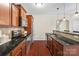 Kitchen with stainless steel appliances, granite countertops, and dark wood cabinets and flooring at 1065 Ellis Pond Dr, Rock Hill, SC 29730