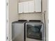 Well-equipped laundry room with modern washer and dryer units, plus storage cabinets at 1065 Ellis Pond Dr, Rock Hill, SC 29730