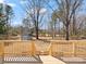 Spacious backyard, viewed from the wooden deck, with a storage shed on the lawn at 10720 Forest Dr, Matthews, NC 28105