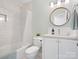 Bathroom featuring bathtub, vanity sink and tiled walls at 10720 Forest Dr, Matthews, NC 28105