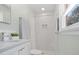 Bright bathroom featuring vanity sink, and subway tiled shower with glass door at 10720 Forest Dr, Matthews, NC 28105
