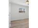 Light-filled bedroom with wood-look floors and large window at 10720 Forest Dr, Matthews, NC 28105