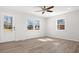 Bright bedroom featuring wood-look floors and windows providing natural light at 10720 Forest Dr, Matthews, NC 28105