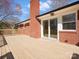 A spacious deck with modern railings offering outdoor living space, accessible from the house through sliding glass doors at 10720 Forest Dr, Matthews, NC 28105