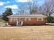 Charming brick home with updated windows, shutters, and a well-maintained front yard, creating a welcoming curb appeal at 10720 Forest Dr, Matthews, NC 28105