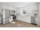 Updated kitchen features stainless steel appliances, white subway tile backsplash, and quartz countertops at 10720 Forest Dr, Matthews, NC 28105