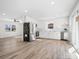 Bright and airy kitchen featuring white cabinets, stainless steel appliances, and hardwood floors at 10720 Forest Dr, Matthews, NC 28105