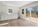 Updated kitchen with white cabinets, stainless steel appliances, and sliding door to outdoor deck at 10720 Forest Dr, Matthews, NC 28105
