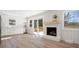 Modern kitchen and living room featuring a fireplace and sliding glass doors leading to an outdoor deck at 10720 Forest Dr, Matthews, NC 28105