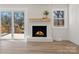 Bright and airy living room featuring a fireplace and sliding doors that open to the outside deck at 10720 Forest Dr, Matthews, NC 28105