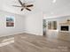 Spacious living room with wood-look floors, a fireplace, and access to the backyard at 10720 Forest Dr, Matthews, NC 28105