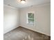 Bedroom featuring neutral carpet and a window at 11005 Cobb Creek Ct, Charlotte, NC 28277