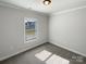Bedroom with gray carpet, a window, and clean white walls at 11005 Cobb Creek Ct, Charlotte, NC 28277