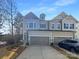 Exterior of a home with a gray color scheme, two-car garage, and well-manicured landscaping at 11005 Cobb Creek Ct, Charlotte, NC 28277