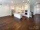Open-concept living space featuring a gourmet kitchen and gleaming hardwood floors at 11005 Cobb Creek Ct, Charlotte, NC 28277