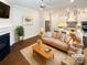Comfortable and stylish living room with a fireplace and an adjacent gourmet kitchen at 11005 Cobb Creek Ct, Charlotte, NC 28277