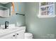 Bright bathroom with round mirror, and white vanity at 11132 White Stag Dr, Charlotte, NC 28269