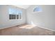 Bright bedroom featuring neutral walls, carpet, and dual windows providing ample natural light at 11132 White Stag Dr, Charlotte, NC 28269