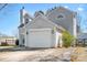 Attached two-car garage with an arched window and driveway at 11132 White Stag Dr, Charlotte, NC 28269