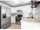 Kitchen boasts white cabinets and stainless steel appliances, combining style and functionality at 11132 White Stag Dr, Charlotte, NC 28269