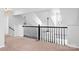 Second floor landing area featuring a metal railing overlooking the living room at 11132 White Stag Dr, Charlotte, NC 28269