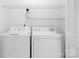 Laundry room with white washer and dryer units, and wire shelving above at 11132 White Stag Dr, Charlotte, NC 28269