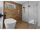 Modern bathroom featuring a sleek freestanding tub and a glass enclosed shower with marble accents at 119 Mills Garden Rd, Statesville, NC 28625