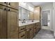 Well-lit bathroom featuring double sinks, modern fixtures, wooden cabinets and tile flooring at 119 Mills Garden Rd, Statesville, NC 28625