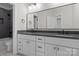 Bathroom featuring double vanity with dark countertop and tiled shower with modern fixtures at 119 Mills Garden Rd, Statesville, NC 28625