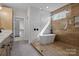 Well-appointed bathroom featuring a freestanding tub, separate shower, and a spacious vanity at 119 Mills Garden Rd, Statesville, NC 28625