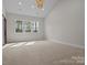 Spacious bedroom featuring a large window with natural light and plush carpet flooring at 119 Mills Garden Rd, Statesville, NC 28625