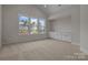 Light-filled room with large windows, built-in cabinets and plush carpet; perfect for relaxation and comfort at 119 Mills Garden Rd, Statesville, NC 28625