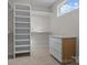 Organized walk-in closet with built-in shelving and ample storage space for clothes and accessories at 119 Mills Garden Rd, Statesville, NC 28625
