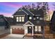 Beautiful exterior elevation with dark siding, wood garage door, and tasteful architectural details at 119 Mills Garden Rd, Statesville, NC 28625