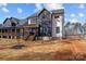 Rear elevation of home with stained wood porch and a view of the spacious backyard at 119 Mills Garden Rd, Statesville, NC 28625