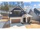 Modern two-story home showcasing a dark exterior, white trim, attached two car garage, and manicured front yard at 119 Mills Garden Rd, Statesville, NC 28625
