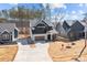 Wide shot of a modern home showcasing professional landscaping and an extended driveway at 119 Mills Garden Rd, Statesville, NC 28625