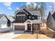 Beautiful new construction home featuring a striking dark exterior with white accents and a two-car garage at 119 Mills Garden Rd, Statesville, NC 28625