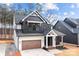 Charming two-story home with a dark exterior, contrasting white accents, and a welcoming front porch at 119 Mills Garden Rd, Statesville, NC 28625