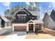 Charming two-story home with a large front porch and well-maintained landscaping at 119 Mills Garden Rd, Statesville, NC 28625