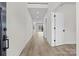Bright hallway with recessed lighting, light walls, and doors with black hardware at 119 Mills Garden Rd, Statesville, NC 28625