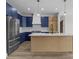 Modern kitchen featuring blue cabinets, white countertops, and stainless steel appliances at 119 Mills Garden Rd, Statesville, NC 28625