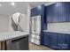 Contemporary kitchen featuring blue cabinets, stainless steel appliances, and marble countertops at 119 Mills Garden Rd, Statesville, NC 28625