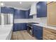 Kitchen with stainless steel oven, navy cabinets and stylish marble backsplash at 119 Mills Garden Rd, Statesville, NC 28625
