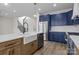 Bright kitchen with a large island, white countertops, navy cabinets, and stainless steel appliances at 119 Mills Garden Rd, Statesville, NC 28625