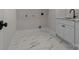 Well-lit laundry room features modern appliances, a granite countertop, and stylish tile flooring at 119 Mills Garden Rd, Statesville, NC 28625