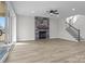 Open-concept living room with a stone fireplace, large windows, and light hardwood floors at 119 Mills Garden Rd, Statesville, NC 28625