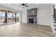 Bright living room showcasing the fireplace, ceiling fan, and sliding door access to deck at 119 Mills Garden Rd, Statesville, NC 28625