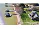Gorgeous aerial view showcasing private beach, boat docks, and manicured lawn at 126 Anchor Ln, Troutman, NC 28166